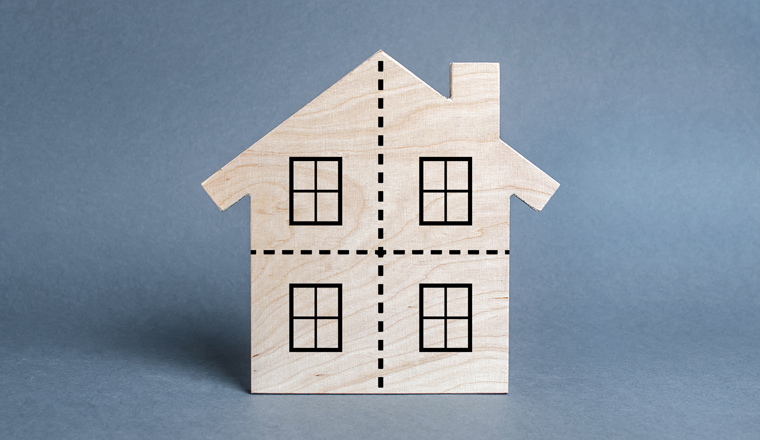 Residential building divided by a dotted line into four equal parts. Divorce concept. Disputes over division process of real estate and property after divorce. Distribution of the right