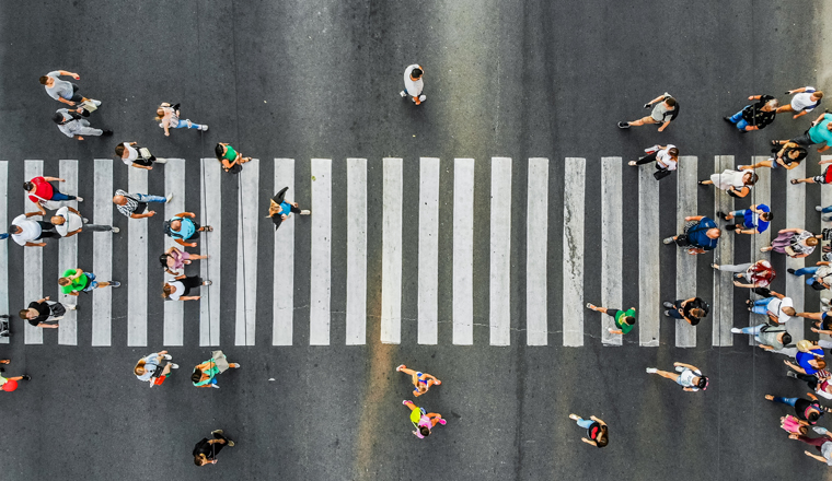 Aerial. Pedestrians on a zebra crosswalk. Top view.