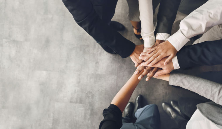 Business unity. Corporate team putting hands together, panorama with free space, top view