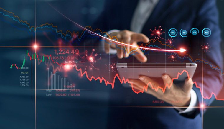 Economic crisis, Businessman using tablet analyzing sales data and economic graph chart that is falling due to the corona virus crisis, Covid-19, stock market crash caused.