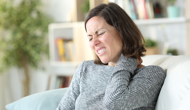 Adult woman suffering painful nechacke at home