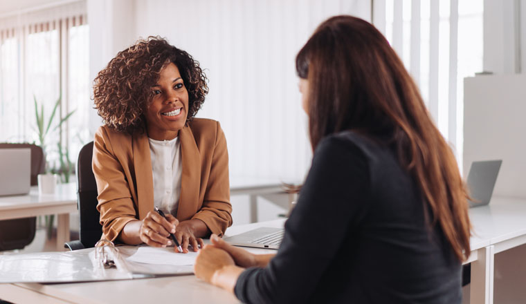 Female financial consultant manager talking with a client at the bank