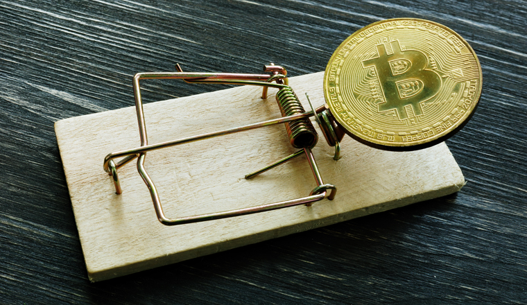 Mousetrap and bitcoin coin. Cryptocurrency scam or fraud concept.