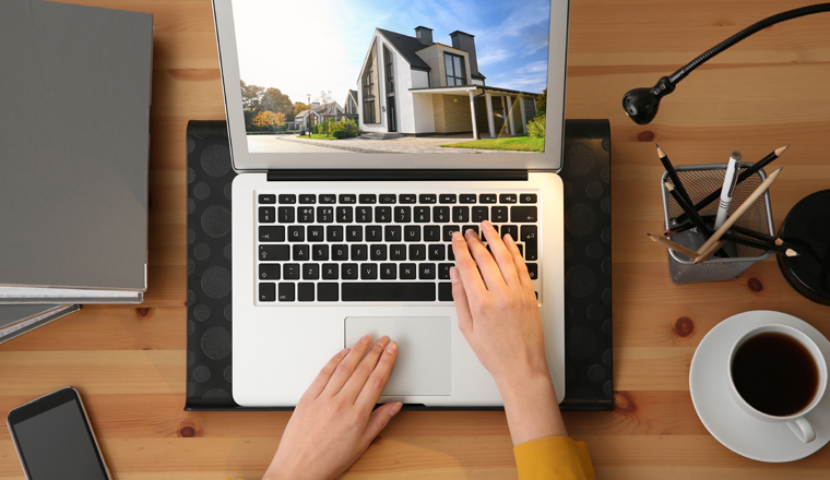 Businesswoman or real estate agent looking through online property portfolio, top view