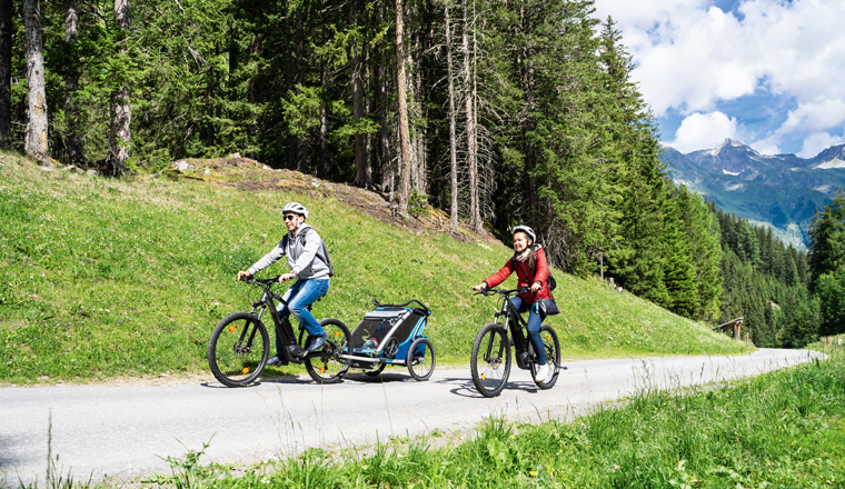 Family With E Bike MTB And Kid Trailer Training