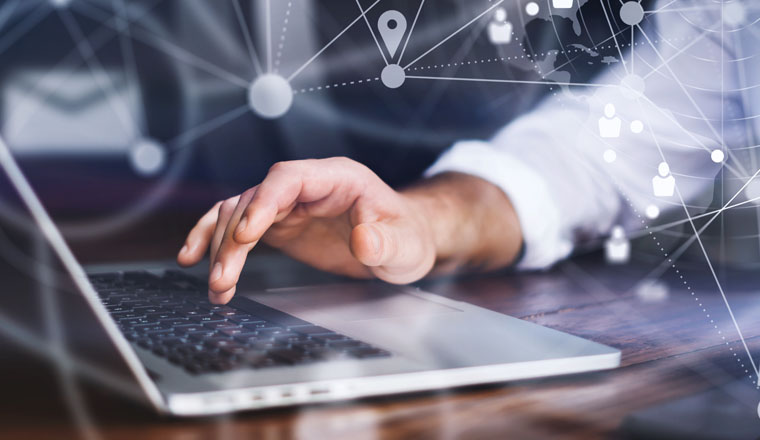 Close-up photo of male hands with laptop. Man working remotely at home. Concept of networking or remote work. Global business network. Online courses.