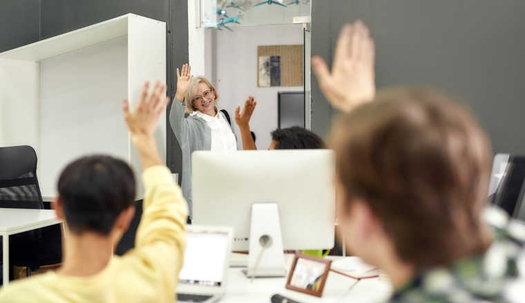 Cheerful aged woman, senior intern waving, saying goodbye to her young colleagues while leaving office after first day at work, Selective focus, Web Banner