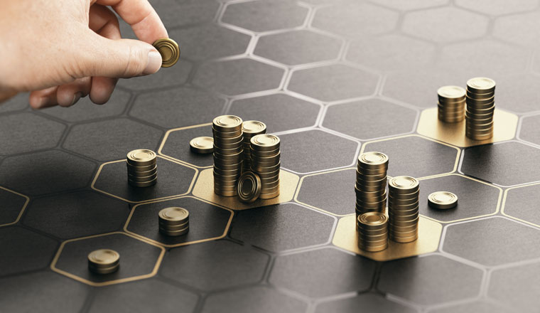 Human hand stacking generic coins over a black background with hexagonal golden shapes. Concept of investment management and portfolio diversification. Composite image between a hand photography and a 3D background.