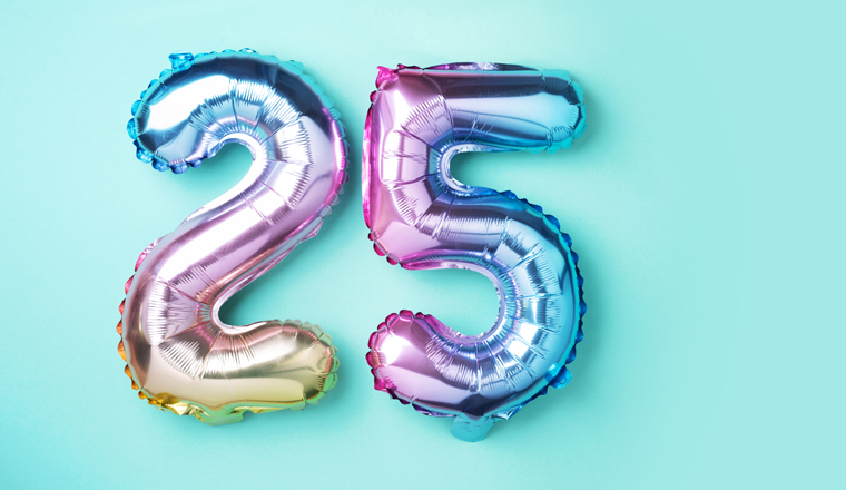Rainbow foil balloon number, digit twenty-five. Birthday greeting card with inscription 25. Anniversary concept. Top view. Colored numeral on blue background. Numerical digit, Celebration event.