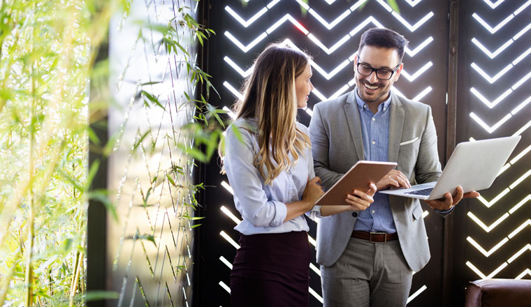 Happy business colleagues at meeting in modern office interior