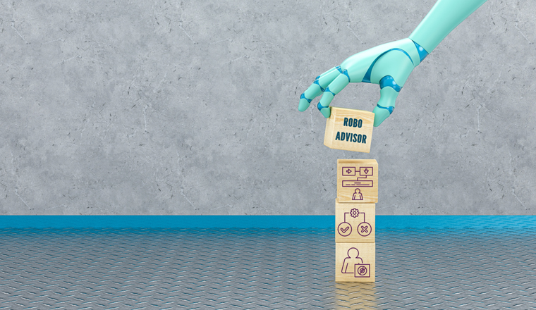 robot hand adding a cube with the text ROBO ADVISOR to a stack of cubes with business icons in front of an industrial background