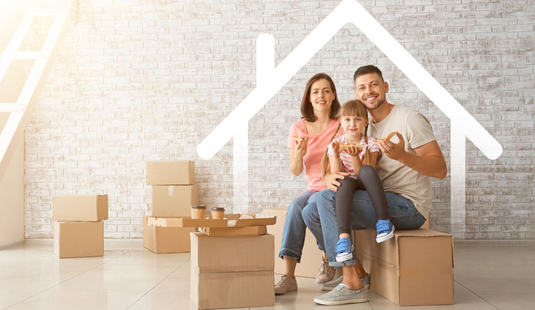 Happy family with cardboard boxes in their new house