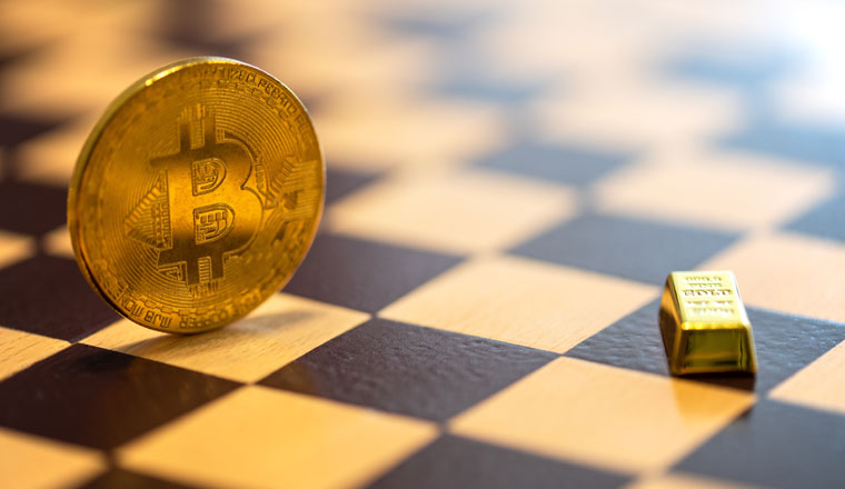 Bitcoin vs gold concept - bitcoin coin and small gold bar on chessboard. Selective focus on the word gold