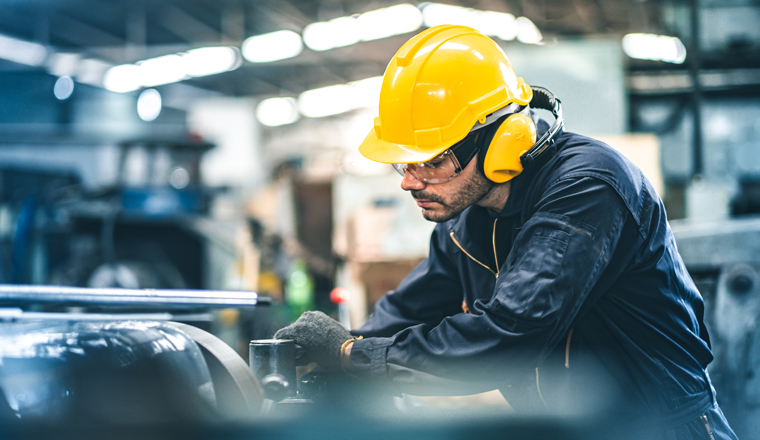 Industrial Engineers in Hard Hats.Work at the Heavy Industry Manufacturing Factory.industrial worker indoors in factory. man working in an industrial factory.Safety first concept.