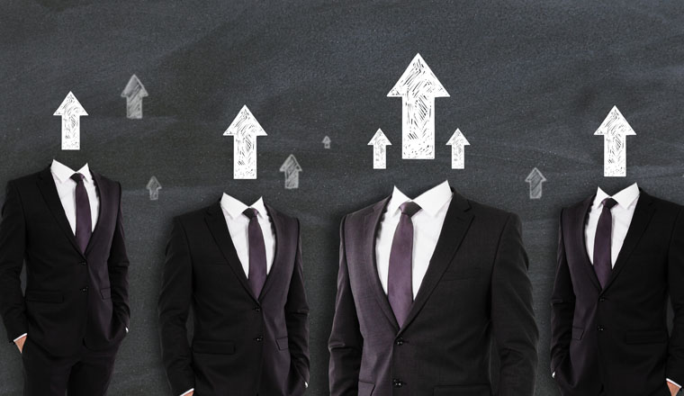 Arrow headed businessmen standing on chalkboard wall background. Success and career growth concept