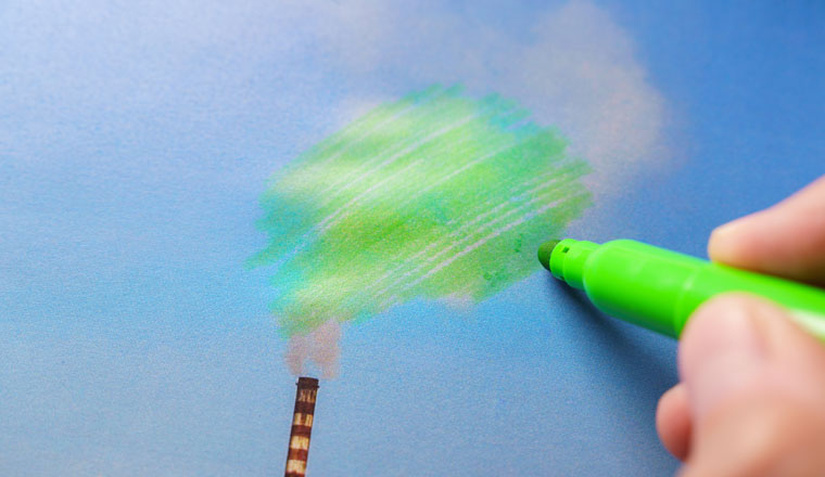 Man painting green pollution from a chimney. greenwashing malpractice concept