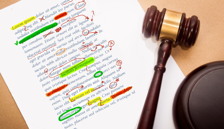 A gavel and soundboard on top of a "Last Will and Testament" contract, with a antique-like background.