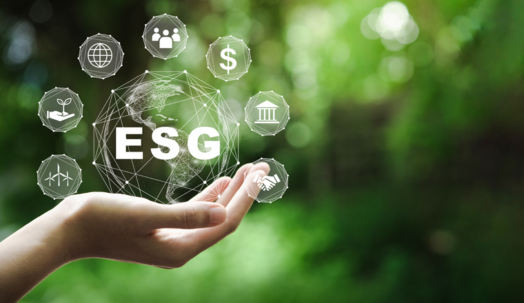 ESG icon concept in the hand for environmental, social, and governance in sustainable and ethical business on the Network connection on a green background.