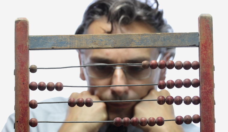accountant with abacus over white bacground