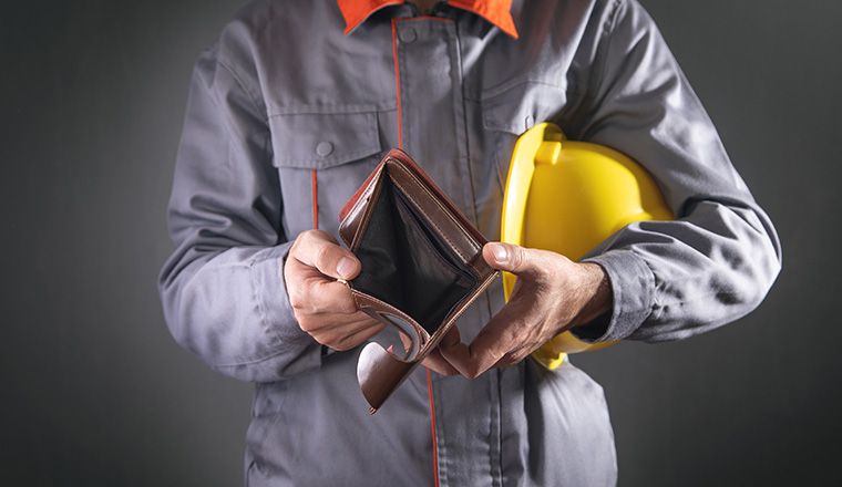 Construction worker holding empty wallet.