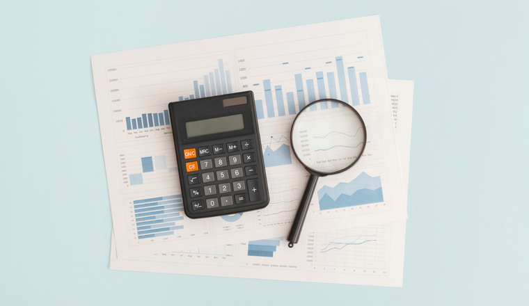 Business graphs, charts, magnifying glass and calculator on table. Financial development, Banking Account, Statistics