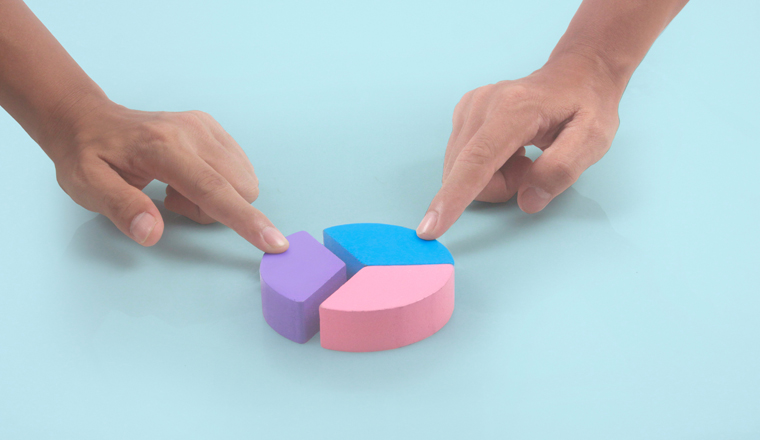 Business connecting piece of multi colored pie wood chart in a hand