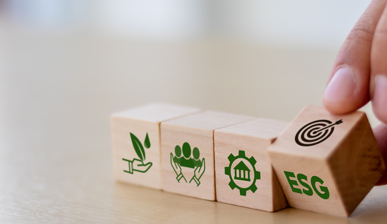 ESG concept of environmental, social and governance. Sustainable corporation development. Hand flips wooden cubes with target setting  to ESG icon with other ESG icons on bright background.Copy space.