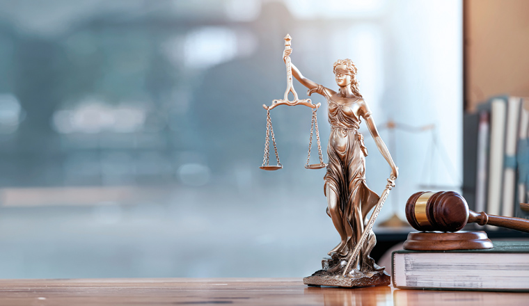 Legal and law concept. Statue of Lady Justice with scales of justice and wooden judge gavel on wooden table. Panoramic image statue of lady justice.