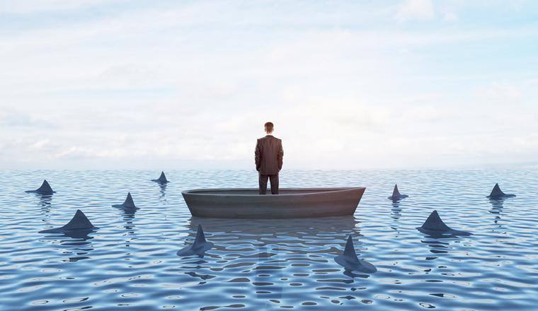 Thoughtful young businessperson on boat standing and looking at surrounding sharks. Mock up place on bright sky with clouds background. Boss and risk concept