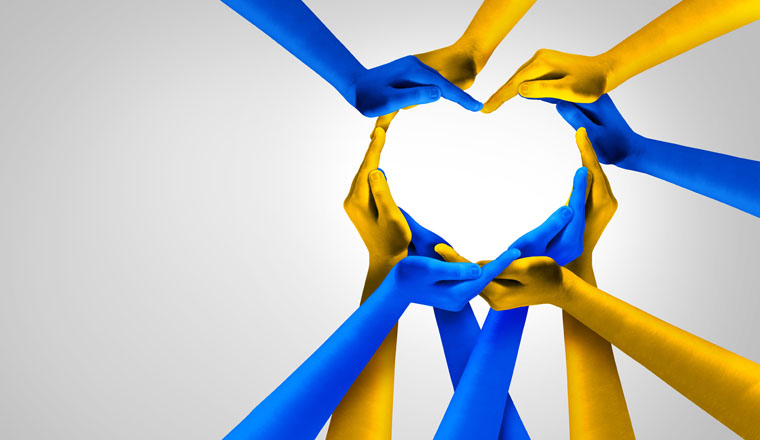 Ukraine And Ukrainian Unity European partnership as heart hands in a group of people connected together shaped as a support symbol expressing the feeling of pride and love for Kyiv in a 3D illustration style.