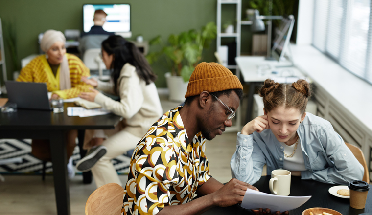 Portrait of two creative young entrepreneurs in business meeting at office, copy space