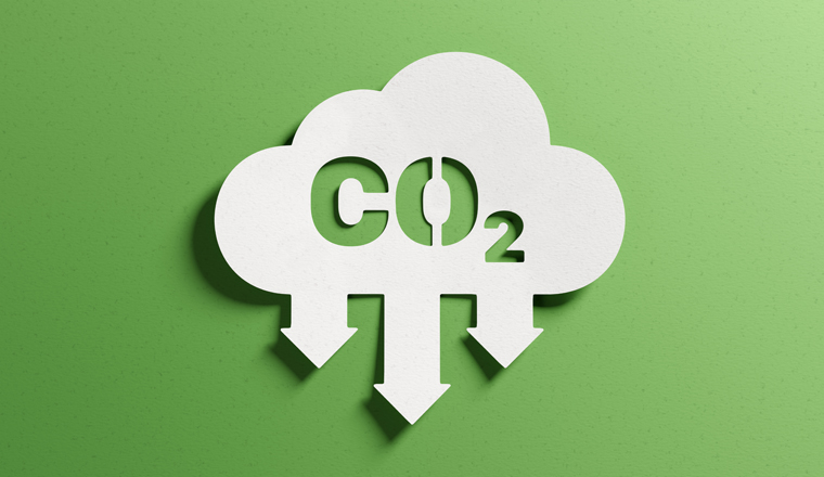 Reduce CO2 emissions to limit climate change and global warming. Low greenhouse gas levels, decarbonize, net zero carbon dioxide footprint. Abstract minimalist design, cutout paper, green background.