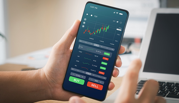 Businessmen work with stock market investments using smartphones to analyze trading data. smartphone with stock exchange graph on screen. Financial stock market.