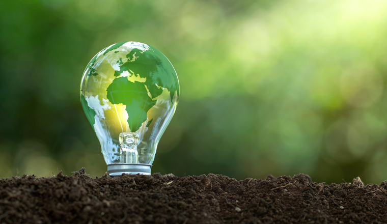 Renewable Energy.Environmental protection, renewable, sustainable energy sources. The green world map is on a light bulb that represents green energy Renewable energy that is important to the world