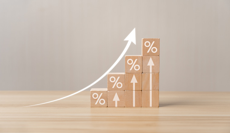 wooden block with percentage sign and up arrow. Concept Percentage of company business growth and sales. interest rate, tax, real estate, increase in income