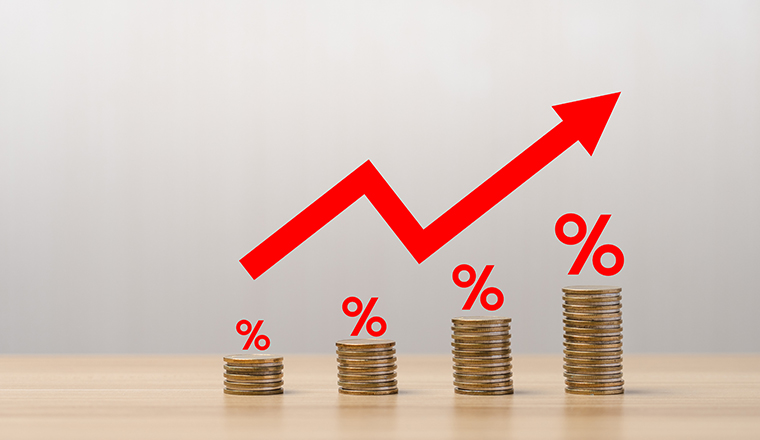 Pile of coins with red arrows showing percentages on the table. The Financial Crisis About Inflation. the concept of higher price inflation and more expensive food