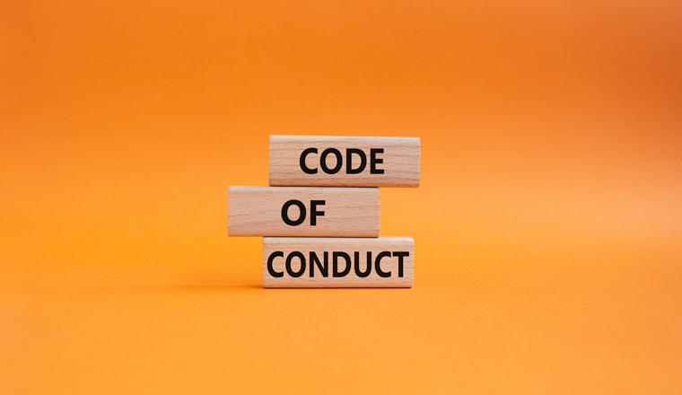 Code of conduct symbol. Wooden blocks with words Code of conduct. Beautiful orange background. Business and Code of conduct concept. Copy space.