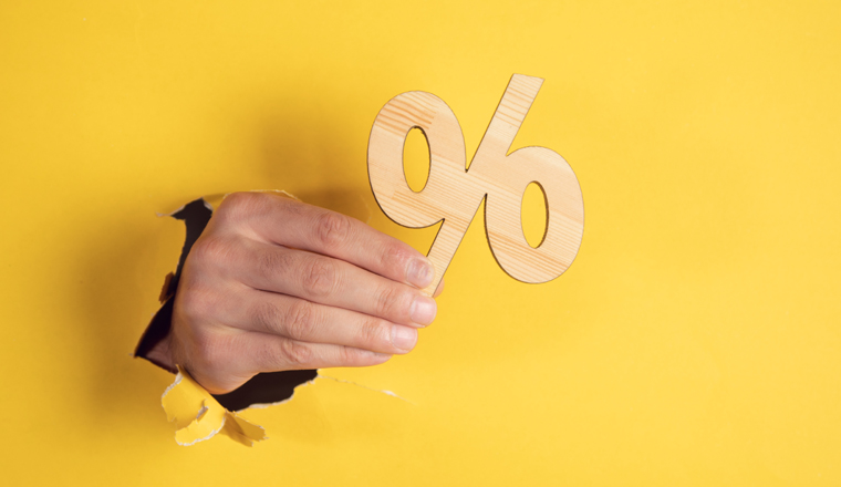 man hand wooden percent on yellow background