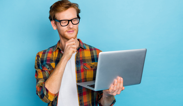 Photo of smart clever thoughtful man hand on chin hold laptop thinking about work task remote job isolated on blue color background.