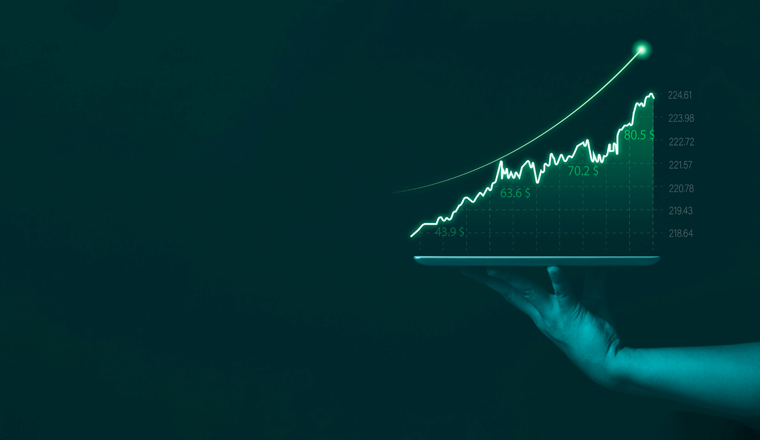 Businessman holding tablet showing stock market graph chart gain profit , Business investment planing growth and economic increasing strategy concept. 