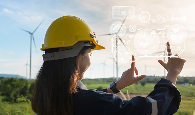 Close up engineering woman hand is touching virtual reality Analytics engineering data in a field over electrical turbines background