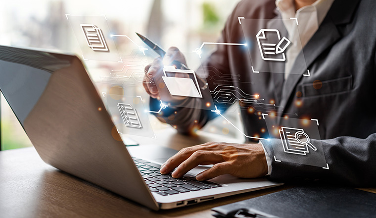 Businessman working and using a computer to manage online documentation database and digital file storage in the office, Document Management System concept