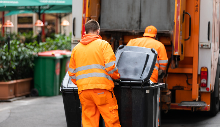 Picture of a garbage truck collecting waste in a big city 