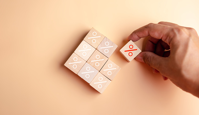 Percentage sign of hand arranging wood blocks stacking as step stair with percent symbol,  interest rate and business profit growth concept.