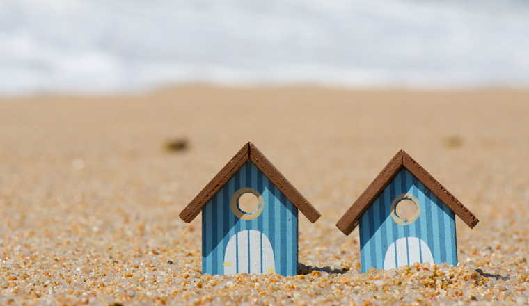 Miniature beach huts with the water line