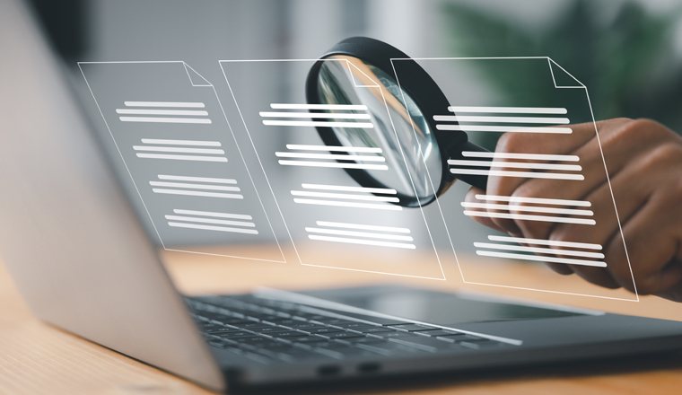 A man inspects paper with a magnifying lens. Business analysis, auditing, professional document review, inquiry, and inspection are all concepts.