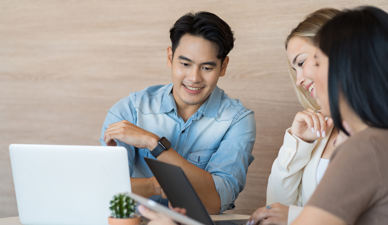 Team of business young man and woman discuss and working with laptop computer in the office workspace. Group of business man and women training or meeting together in the office