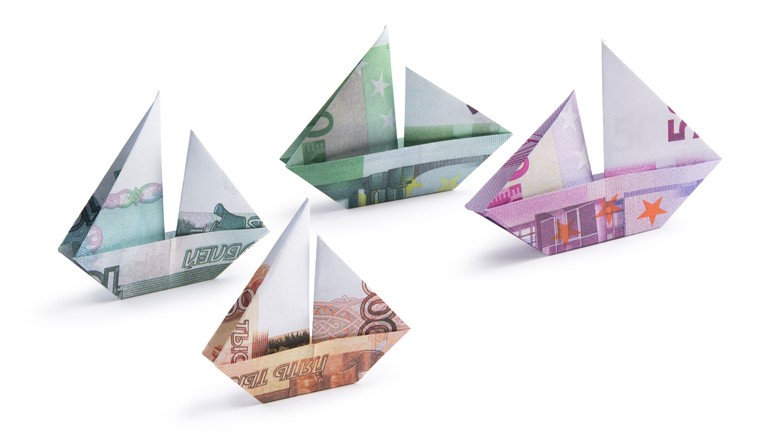 origami ship from banknotes on a white background