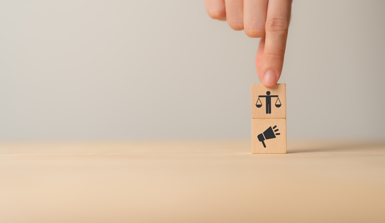 Ethical marketing and communication concept. Using responsible communication and practices that respect the interests of stakeholders. Wooden cube blocks with ethics and marketing communication icons.