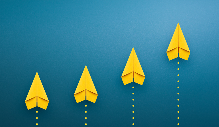 Yellow paper plane on blue background, Success in business growth concept. copy space